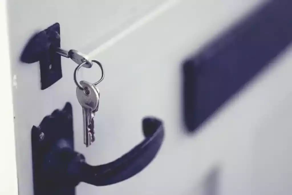 Image of a door with keys sticking out of the lock - pin tumbler lock picking part 1 white oak security