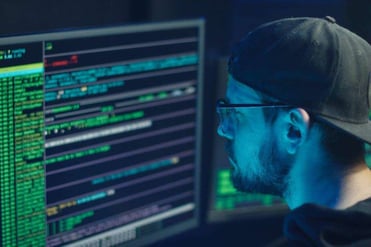 The photo is of a hacker looking at code and tracking pixels located to the right of the White Oak Security blog about a modest investigation into email phishing scam attacks.