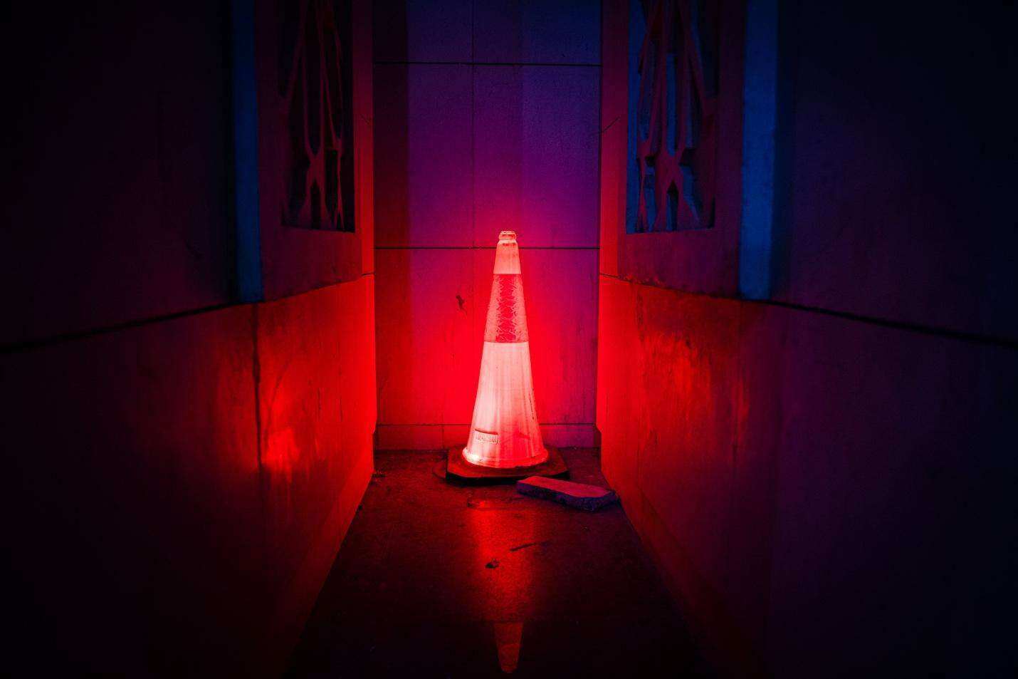 White Oak Security’s Microsoft Office Zero Day: Mitigate NOW blog post image of a lot up traffic cone in a dark hallway meaning ALERT. Photo caption: Free Red Led Traffic Cone Stock Photo
